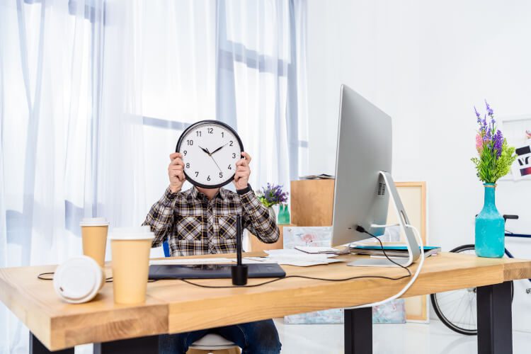 Man with face hidden by clock
