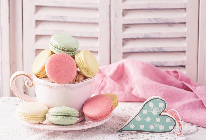 Macaroons and cup of tea. Pastries on table